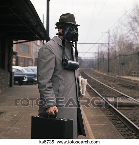 man wearing gas mask hat train briefcase View Large Photo Image Stock Photography - man wearing gas mask hat train briefcase. Fotosearch