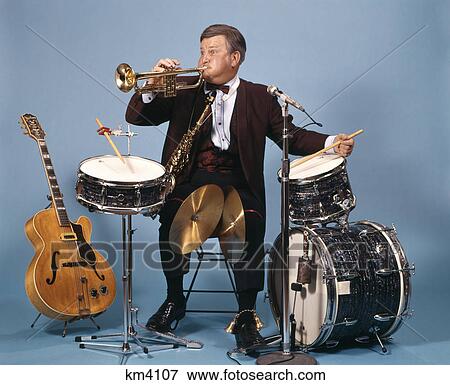 Stock Photo - man with band instruments. Fotosearch