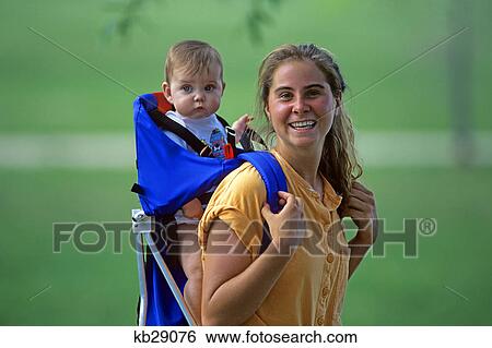 mother carrying child in infant carrier on her back View Large Photo Image Stock Photograph - mother carrying child in infant carrier on her back. Fotosearch