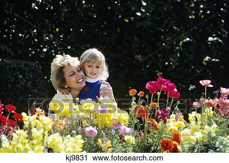 mother hugging daughter in garden View Large Photo Image Stock Image - mother hugging daughter in garden. Fotosearch