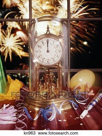 party hat streamers noise maker beside glass domed clock showing midnight fireworks visible out window View Large Photo Image Stock Image - party hat streamers noise maker beside glass domed clock showing midnight fireworks visible out window. Fotosearch