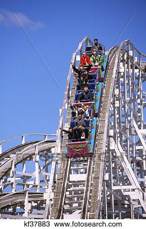 people riding wooden roller coaster at amusement park pennsylvania View Large Photo Image Stock Image - people riding wooden roller coaster at amusement park pennsylvania. Fotosearch