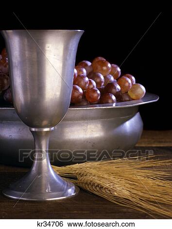 pewter chalice grapes stems of wheat communion still life View Large Photo Image Stock Photograph - pewter chalice grapes stems of wheat communion still life. Fotosearch