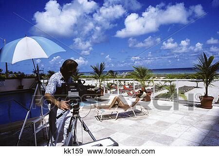 photographer videotaping model View Large Photo Image Stock Photo - photographer videotaping model. Fotosearch