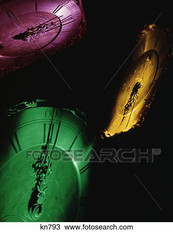 pink yellow and green clock faces at the stroke of midnight new years eve View Large Photo Image Stock Image - pink yellow and green clock faces at the stroke of midnight new years eve. Fotosearch