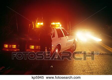 police road block, two police officers behind patrol car and male in oncoming car View Large Photo Image Stock Photography - police road block, two police officers behind patrol car and male in oncoming car. Fotosearch