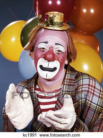 portrait of clown wearing tiny hat clapping his hands with a sad expression View Large Photo Image Stock Image - portrait of clown wearing tiny hat clapping his hands with a sad expression. Fotosearch