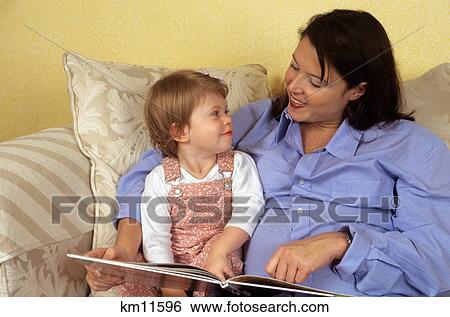pregnant mother reading to daughter on couch View Large Photo Image Stock Photograph - pregnant mother reading to daughter on couch. Fotosearch