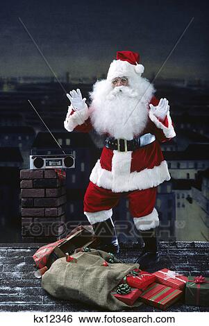 santa claus dancing on a rooftop to radio tunes at night with city in background View Large Photo Image Stock Photograph - santa claus dancing on a rooftop to radio tunes at night with city in background. Fotosearch