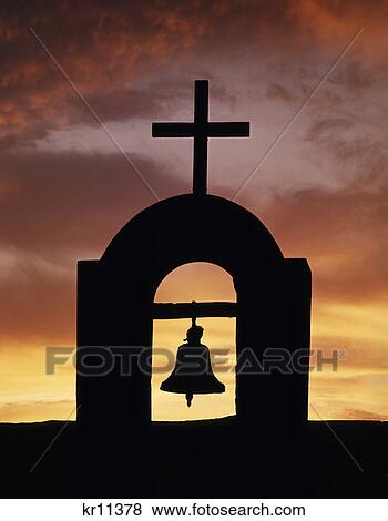silhouetted mission church bell in belfry with cross against golden sunset sky View Large Photo Image Stock Photo - silhouetted mission church bell in belfry with cross against golden sunset sky. Fotosearch