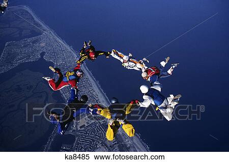 Stock Photography - sky divers forming circle holding hands. Fotosearch