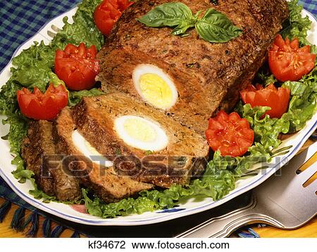 sliced meatloaf with herbs and hard boiled egg in center View Large Photo Image Stock Image - sliced meatloaf with herbs and hard boiled egg in center. Fotosearch