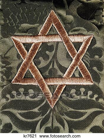 Stock Image - star of david embroidery on green fabric. Fotosearch