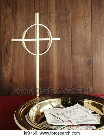 still life gold cross by brass collection plate filled with tithing envelopes View Large Photo Image Stock Photo - still life gold cross by brass collection plate filled with tithing envelopes. Fotosearch