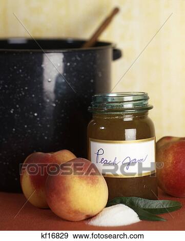 Stock Photo - still life of cooking pot and ingredients for jar of peach jam. Fotosearch