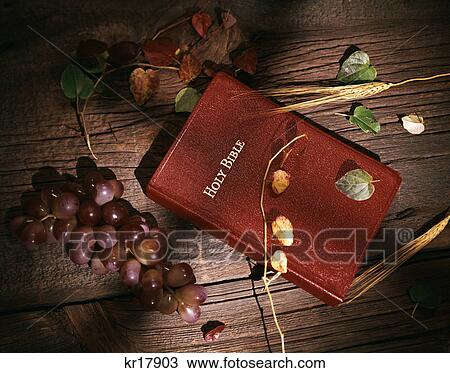 still life of red holy bible on wooden background with grapes & wheat shadow of cross View Large Photo Image Stock Image - still life of red holy bible on wooden background with grapes & wheat shadow of cross. Fotosearch