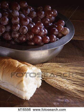 still life of wheat bread and grapes in a silver bowl symbolic of communion View Large Photo Image Stock Photograph - still life of wheat bread and grapes in a silver bowl symbolic of communion. Fotosearch