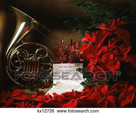 Stock Photograph - the christmas story and sheet music with french horn and poinsettias. Fotosearch