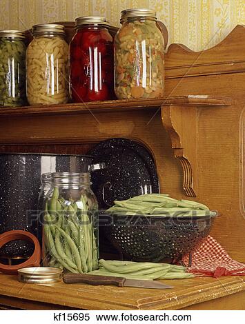 vintage wooden kitchen counter with green beans in colander and jars of canned vegetables View Large Photo Image Stock Photography - vintage wooden kitchen counter with green beans in colander and jars of canned vegetables. Fotosearch