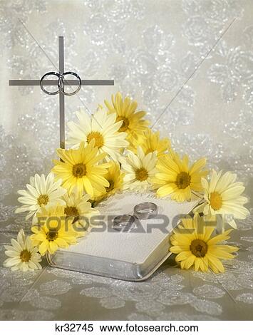 white bible wedding rings silver cross and bright yellow daisies View Large Photo Image Stock Photography - white bible wedding rings silver cross and bright yellow daisies. Fotosearch