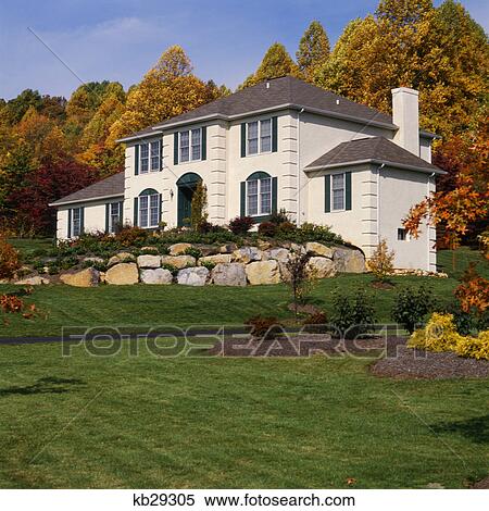 White House With Gray Shutters And Stone Wall In Front Yard Stock Photography White House With Gray Shutters And Stone Wall In Front Yard Stock Photography