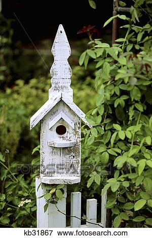white wooden bird house on a fence View Large Photo Image Stock Photo - white wooden bird house on a fence. Fotosearch