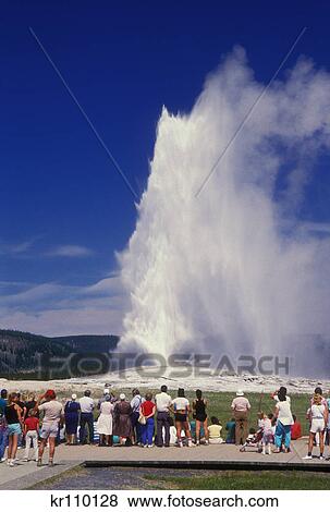 Stock Photo - yellowstone np wy tourists watching old faithful geyser. Fotosearch