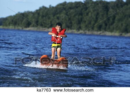 Stock Image - young boy aqua skiing. Fotosearch
