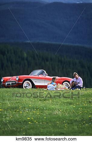 Stock Photography - young couple having picnic beside car winter park colorado. Fotosearch