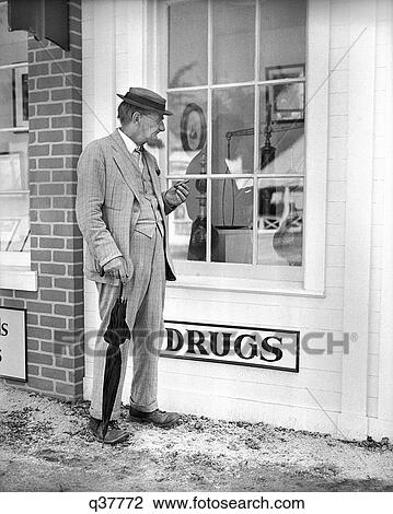 1850S Elderly Man Standing In Front Of Drug Store Window With Apothecary Jars & Scale View Large Photo Image Stock Image - 1850S Elderly Man Standing In Front Of Drug Store Window With Apothecary Jars & Scale. Fotosearch