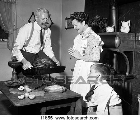 1890S 1900S Mock Turn Of The 20Th Century Thanksgiving Dinner Father Taking Turkey Out Of Wood-Burning Stove Showing It To Wife And Son View Large Photo Image Stock Photography - 1890S 1900S Mock Turn Of The 20Th Century Thanksgiving Dinner Father Taking Turkey Out Of Wood-Burning Stove Showing It To Wife And Son. Fotosearch