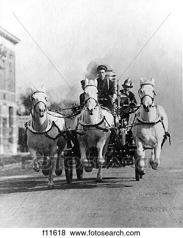 Stock Photo - 1890S 1900S Old-Time Head-On Shot Of Horse-Drawn Fire Truck Racing Down Street. Fotosearch