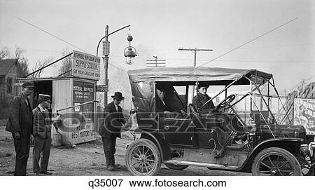 1910S Kansas City Missouri Man Filling Tank Of Old Car At Gasoline Station Next To The Old Santa Fe Trail View Large Photo Image Stock Photo - 1910S Kansas City Missouri Man Filling Tank Of Old Car At Gasoline Station Next To The Old Santa Fe Trail. Fotosearch