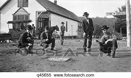 1910S Men Playing Marbles Game Of Hoss In On Streets Of Gainsville Missouri In The Ozark Hill Country View Large Photo Image Stock Photography - 1910S Men Playing Marbles Game Of Hoss In On Streets Of Gainsville Missouri In The Ozark Hill Country. Fotosearch
