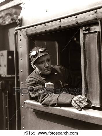 Stock Photography - 1920S 1930S 1940S Railroad Train Engineer Looking Out Window Of Locomotive Cab Driving The Steam Engine. Fotosearch