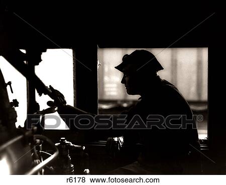 1920S 1930S 1940S Silhouette Train Engineer At Controls In Locomotive Cab Of Railroad Steam Engine View Large Photo Image Stock Photo - 1920S 1930S 1940S Silhouette Train Engineer At Controls In Locomotive Cab Of Railroad Steam Engine. Fotosearch
