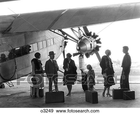 1920S 1930S Group Of Passengers Standing Under Wing Of Ford Tri-Motor Airplane With Baggage View Large Photo Image Stock Photo - 1920S 1930S Group Of Passengers Standing Under Wing Of Ford Tri-Motor Airplane With Baggage. Fotosearch