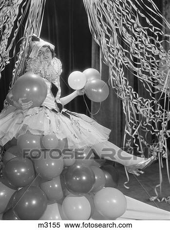 1920S Woman Dressed In Harlequin Costume Sitting On Stack Of Balloons View Large Photo Image Stock Photography - 1920S Woman Dressed In Harlequin Costume Sitting On Stack Of Balloons . Fotosearch