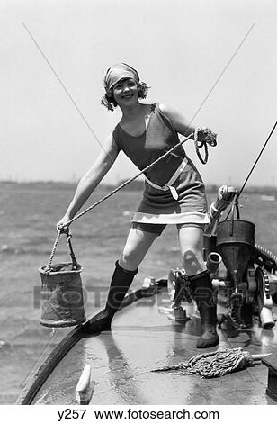 1920S Woman In Bathing Suit Pulling Bucket Of Water Aboard A Boat Outdoor View Large Photo Image Stock Photo - 1920S Woman In Bathing Suit Pulling Bucket Of Water Aboard A Boat Outdoor. Fotosearch