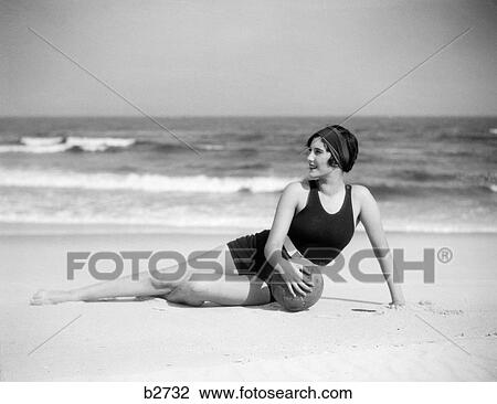 1920S Woman In Bathing Suit Stretched Out On Beach In Front Of Water Holding Ball View Large Photo Image Stock Image - 1920S Woman In Bathing Suit Stretched Out On Beach In Front Of Water Holding Ball. Fotosearch