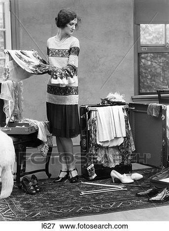 1920S Woman Packing Clothes For Travel View Large Photo Image Stock Photo - 1920S Woman Packing Clothes For Travel. Fotosearch