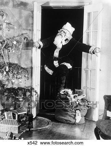 1920S1930S Santa Claus Sneaking Into Living Room Through Double Doors View Large Photo Image Stock Image - 1920S1930S Santa Claus Sneaking Into Living Room Through Double Doors. Fotosearch