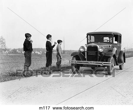 1930S 1920S Man Driving Ford Model A Car 3 Boys Hitchhiking View Large Photo Image Stock Photo - 1930S 1920S Man Driving Ford Model A Car 3 Boys Hitchhiking. Fotosearch