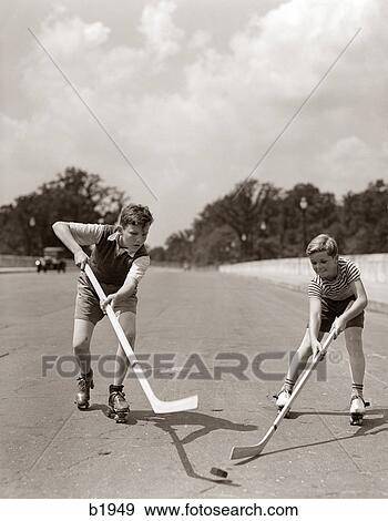 1930S 1940S 2 Boys With Sticks And Puck Wearing Roller Skates Playing Street Hockey View Large Photo Image Stock Photo - 1930S 1940S 2 Boys With Sticks And Puck Wearing Roller Skates Playing Street Hockey. Fotosearch