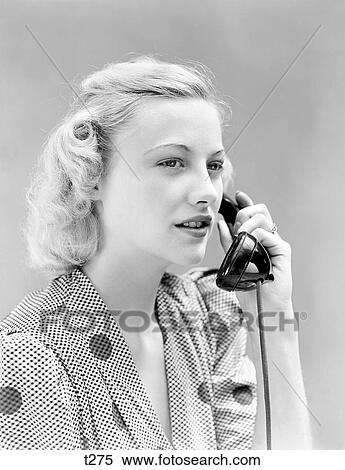 Stock Photography - 1930S 1940S Blond Woman Talking On Telephone Waring Polka-Dot Dress Smiling . Fotosearch