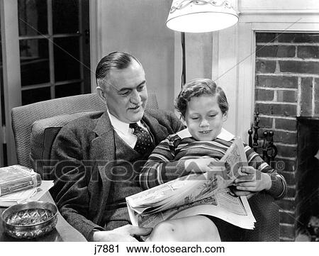 1930S 1940S Father Sitting With Son On Lap Reading Sunday Newspaper Comics Together In Living Room View Large Photo Image Stock Image - 1930S 1940S Father Sitting With Son On Lap Reading Sunday Newspaper Comics Together In Living Room. Fotosearch