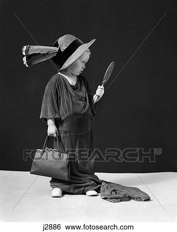 1930S 1940S Girl Playing Dress-Up Looking At Herself In Hand Mirror View Large Photo Image Stock Photograph - 1930S 1940S Girl Playing Dress-Up Looking At Herself In Hand Mirror. Fotosearch