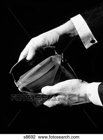 Stock Image - 1930S 1940S Hands Close-Up Holding And Showing Empty Wallet Has No Money. Fotosearch