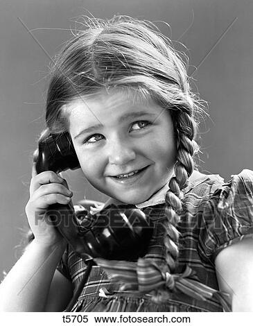 1930S 1940S Portrait Of Smiling Little Girl With Long Pigtails Talking On Telephone View Large Photo Image Stock Photography - 1930S 1940S Portrait Of Smiling Little Girl With Long Pigtails Talking On Telephone. Fotosearch