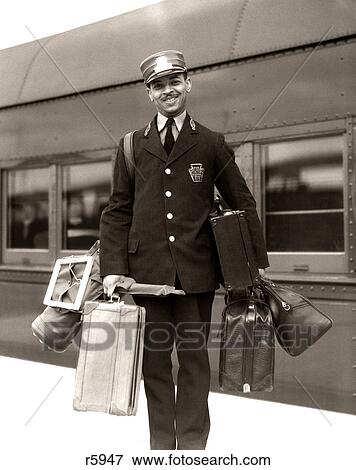 1930S 1940S Portrait Smiling African American Man Red Cap Porter Carrying Luggage Bags Suitcases Passenger Railroad Train View Large Photo Image Stock Photo - 1930S 1940S Portrait Smiling African American Man Red Cap Porter Carrying Luggage Bags Suitcases Passenger Railroad Train. Fotosearch